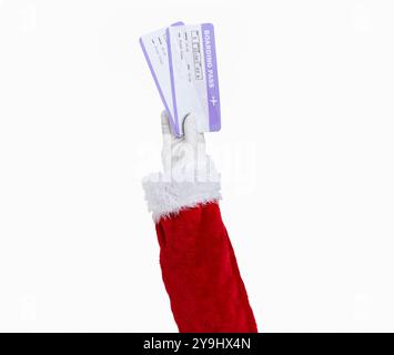 Shot of an Santa Claus hand holding a airline boarding pass isolated on a white background Stock Photo