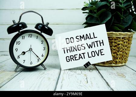 Inspirational quote Do Somthing Awesome Today text message with alarm clock on wooden background Stock Photo