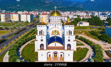 Aerial view of the Church of St. Jovan Vladimir in Bar, Montenegro - Serbian Orthodox church with two bell towers and gilded domes at the center of a Stock Photo