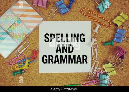 Spelling and Grammar text on paper card with stationery on cork board background Stock Photo