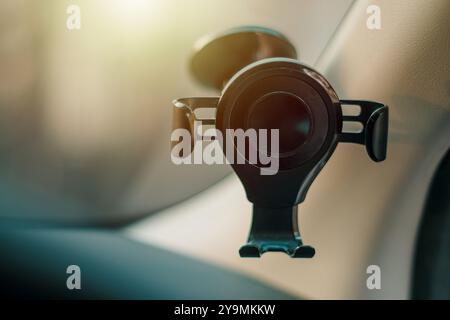 Black phone holder with gravity mount inside a car Stock Photo