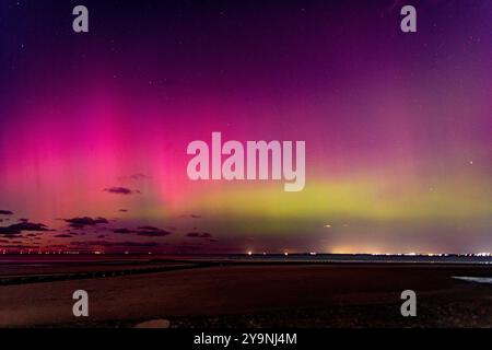 Vivid display of the northern lights over the beach at New Brighton, Wirral, England Stock Photo