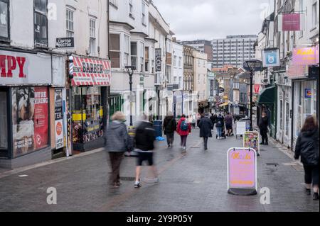 Shoppers walk up and down Gabriels Hill in Maidstone on a wet day Stock Photo