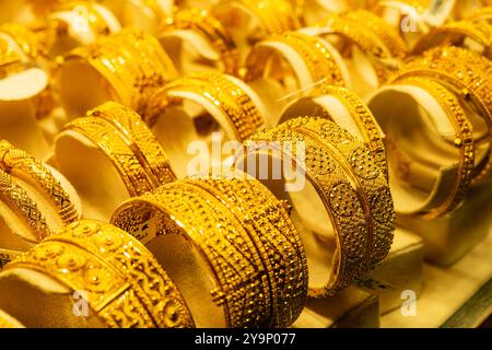 Luxurious gold bracelets on the background. Group of beautiful and elegant gold jewelry - bracelet, expensive accessory Stock Photo