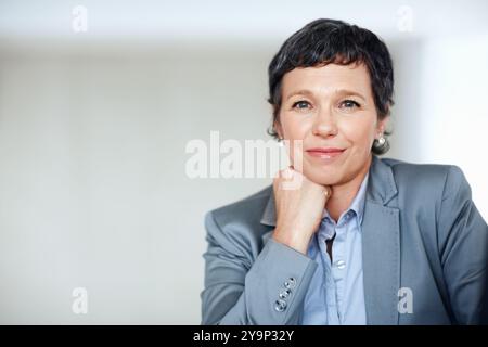 Business, mockup and portrait with mature woman at desk in office for professional management career. Company, corporate and space with confident Stock Photo