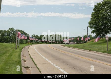 Curved road lined with American flags on both sides Stock Photo