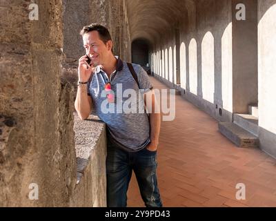 Portrait of handsome traveler man using his mobile. Stock Photo