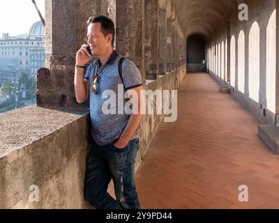 Portrait of handsome traveler man using his mobile. Stock Photo