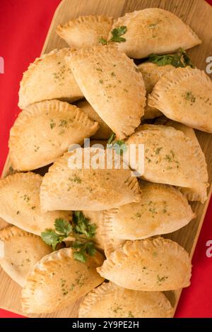 Meat Pies Stacked on a cutting board Stock Photo