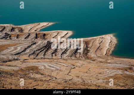 Salt formations on the shore of a lake in a desert landscape Stock Photo