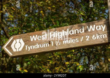 Wooden way marker for the West Highland Way pointing to Tyndrum, Perthshire, Scotland Stock Photo