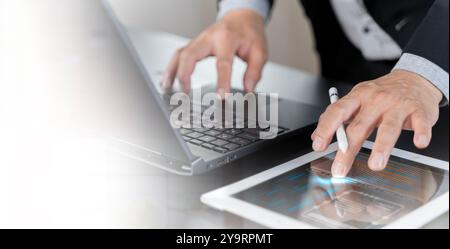 Businessman working on laptop, using mobile phone at modern office, analyzing business document with financial graph, market report on digital tablet, Stock Photo