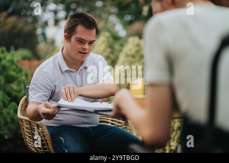 Young man with Down syndrome enjoying outdoor meeting Stock Photo