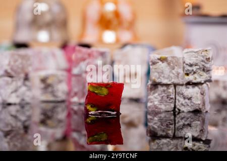 Turkish delight in different flavours with various fillings including pistachios, produced in a workshop in the Turkish town of Gaziantep. Turkish delight or lokum is a sweet Turkish delicacy which comes in many varieties and combinations Stock Photo