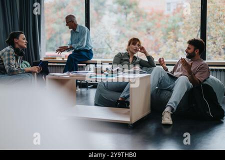Professor engaging with students in modern classroom setting Stock Photo