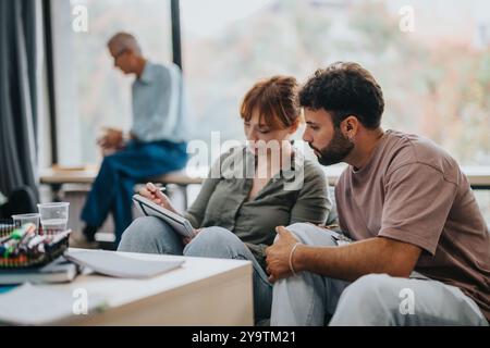 Engaged students collaborating in a modern classroom setting Stock Photo