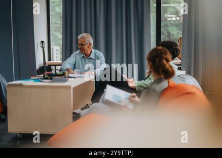 Professor engaging with students in relaxed classroom setting Stock Photo