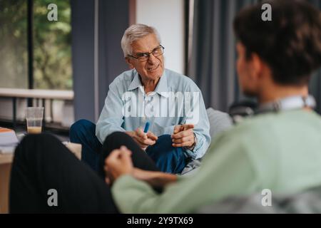 Professor engaging in thoughtful discussion with attentive students Stock Photo