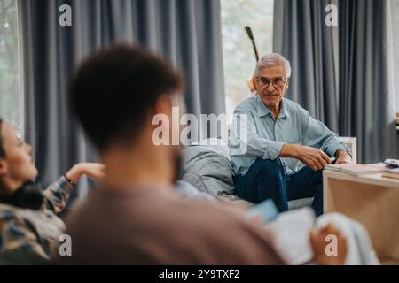 Professor engaging with students in casual setting discussion Stock Photo