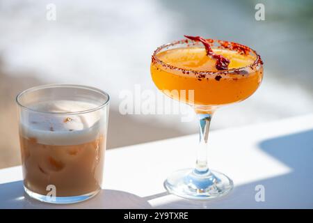 A stunning arrangement of red chili margarita cocktails set against a breathtaking sea view, perfect for a refreshing beachside experience. Stock Photo