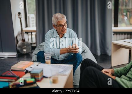 Professor engaging with students in a relaxed environment Stock Photo