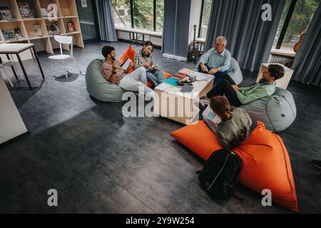 Professor engaging with students in a relaxed learning environment Stock Photo