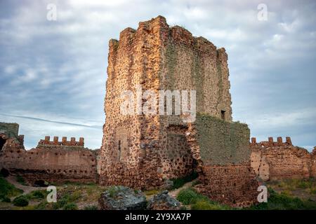 Detail of the main tower of the medieval walled castle of Almoacid in Toledo, Castilla la Mancha, Spain, with morning light and beautiful clouds Stock Photo