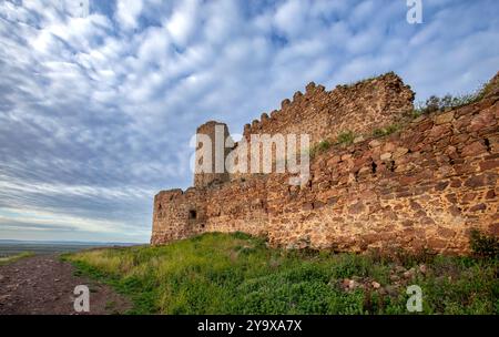 View of the medieval walled castle of Almoacid in Toledo, Castilla la Mancha, Spain, with morning light and beautiful clouds Stock Photo