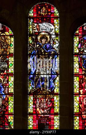 France, Vosges, Saint Die des Vosges, Saint Martin church built by architect Charles Heubes in 1896, inaugurated in 1902 in neo roman style, modern stained glass window made between 1947 and 1949 by Jacques Le Chevallier representing Joan of Arc Stock Photo