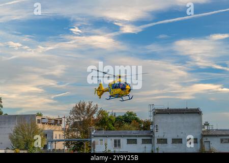 Emergency yellow czech helicopter start fly in sunset blue sky in Ceske Budejovice CZ 10 09 2024 Stock Photo