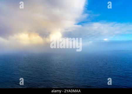 Ocean weather change from blue sky to low clouds and foggy conditions Stock Photo