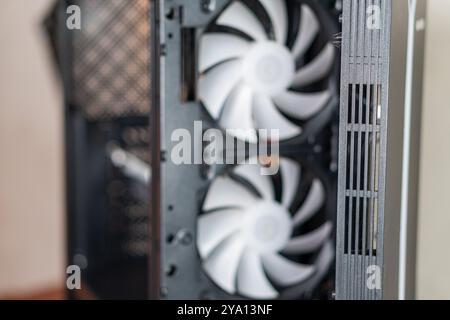 Close-up view of a computer case featuring two large cooling fans. The fans are white with a sleek design, mounted on a black panel. The case has a mo Stock Photo