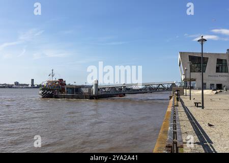 Ferry on the river in front of a modern building, quiet river landscape, Liverpool Stock Photo