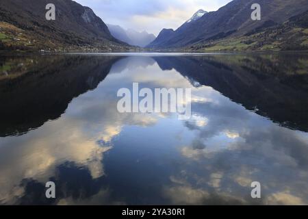 View of the Innvikfjorden near Loen in Norway. The landscape is reflected in the water Stock Photo