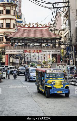 Jeepney and busy street urban traffic in central manila city chinatown philippines Stock Photo