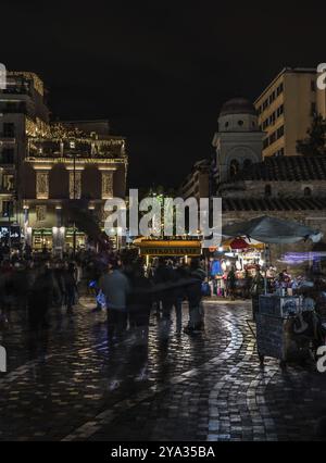 Athens Old Town, Attica, Greece, 12 28 2019 Locals and tourists walking over the Monastiraki Square by night, Europe Stock Photo