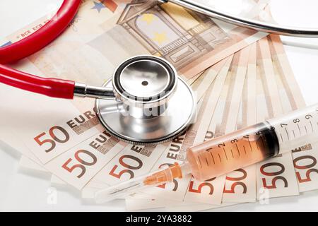 Stethoscope and syringe are on 50 euro notes Stock Photo