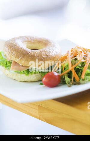 Smoked salmon bagel and side salad Stock Photo