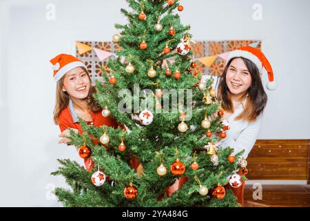 Joyful Holiday Moments Friends Gather Together to Decorate a Christmas Tree Stock Photo