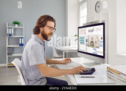 Accountant or businessman working on computer and using multiple apps and calculator Stock Photo