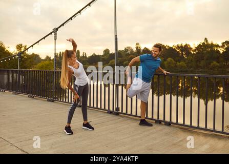 Young fit and active couple doing sport exercising in nature. Outdoors fitness concept. Stock Photo
