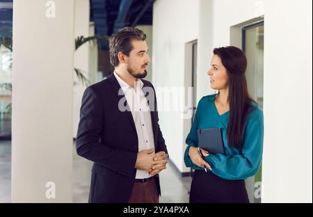 Colleagues, office people, businessmen discussing project strategy standing, sharing ideas Stock Photo