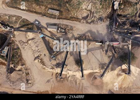 Aerial view of stone quarry conveyor belt system in operation, stone jaw crusher plant Stock Photo