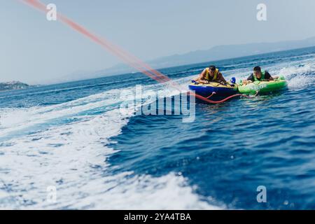 Exciting summer speedboat tubing adventure on the sea with friends Stock Photo