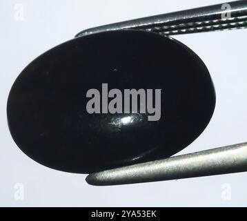 Polished Black Onyx Gemstone Showcasing Its Glossy Surface and Subtle Reflections. Stock Photo