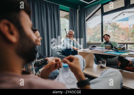 Professor engaging with students in a comfortable study space Stock Photo