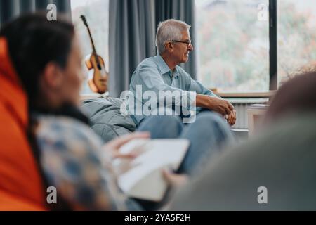 Professor engaging with students in a relaxed classroom setting Stock Photo
