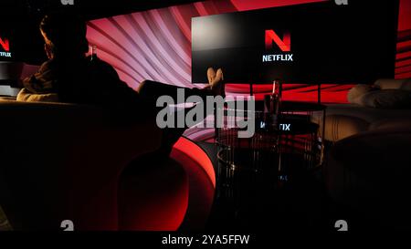 A man enjoy watching netflix on huge tv screen Stock Photo