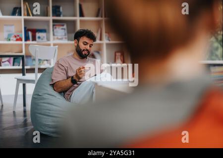 Professor engaging with students in a relaxed classroom setting Stock Photo