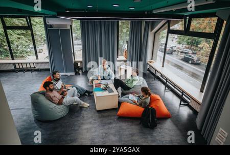 Professor engaging with students in a modern study space Stock Photo
